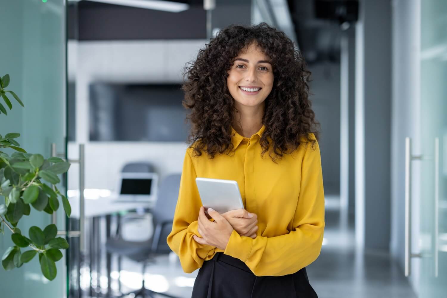 A woman in a yellow shirt smiling