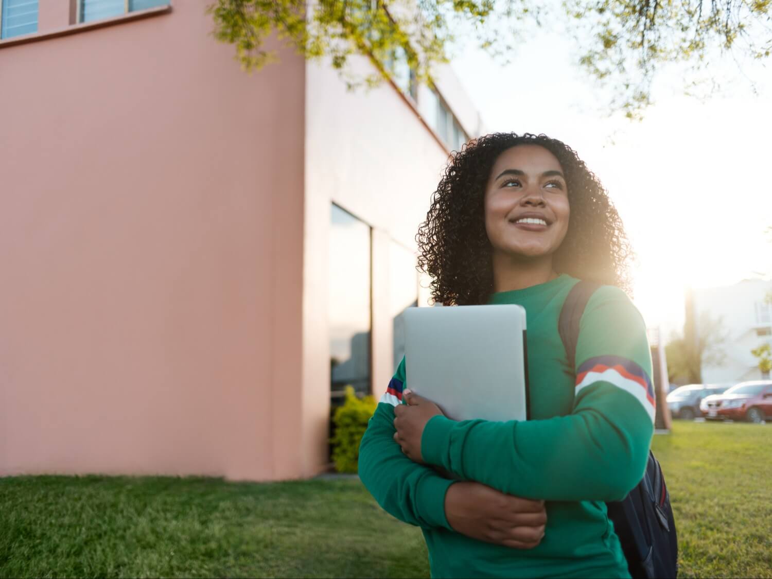 Student smiling holding notebook