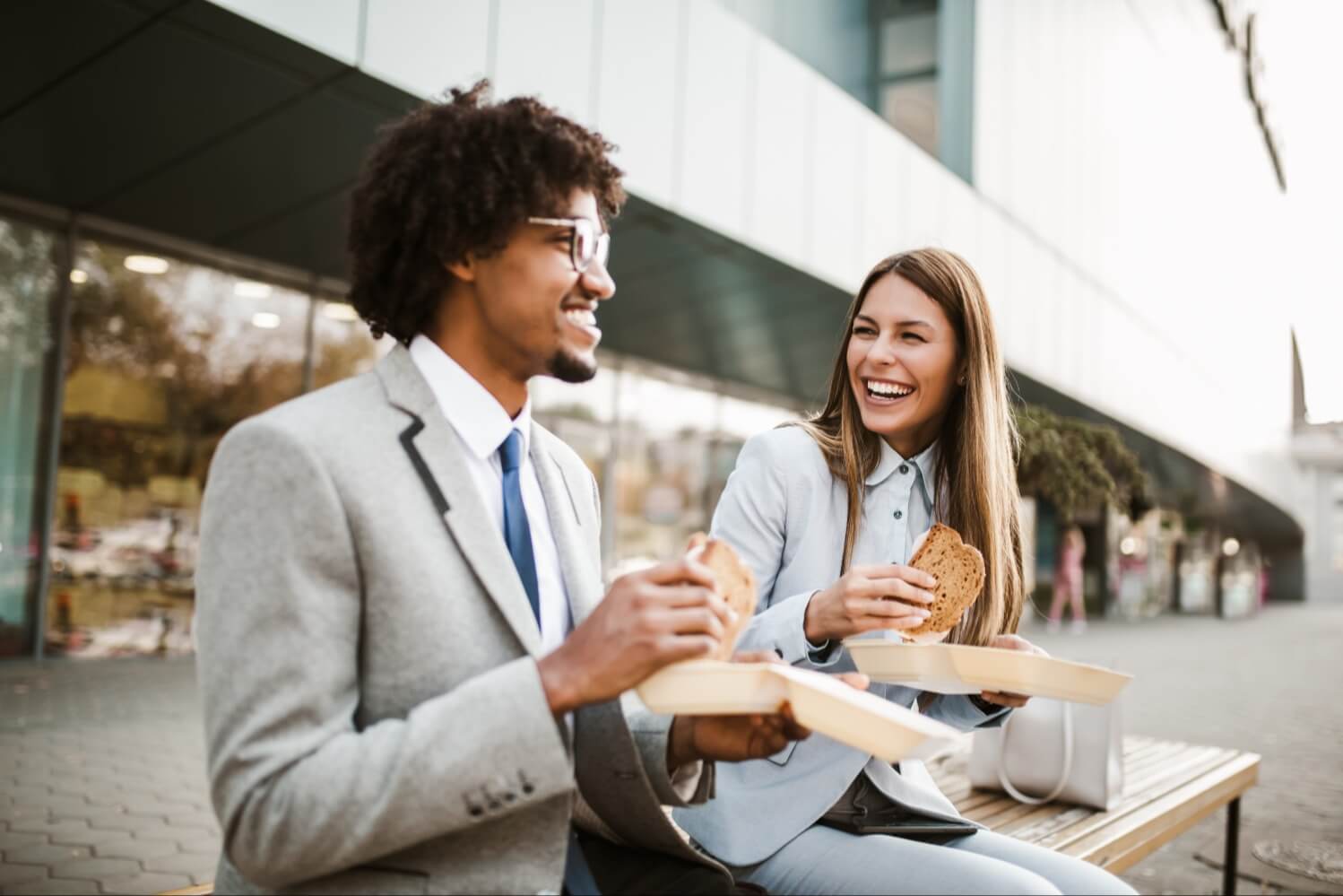 Businessman and businesswoman eating