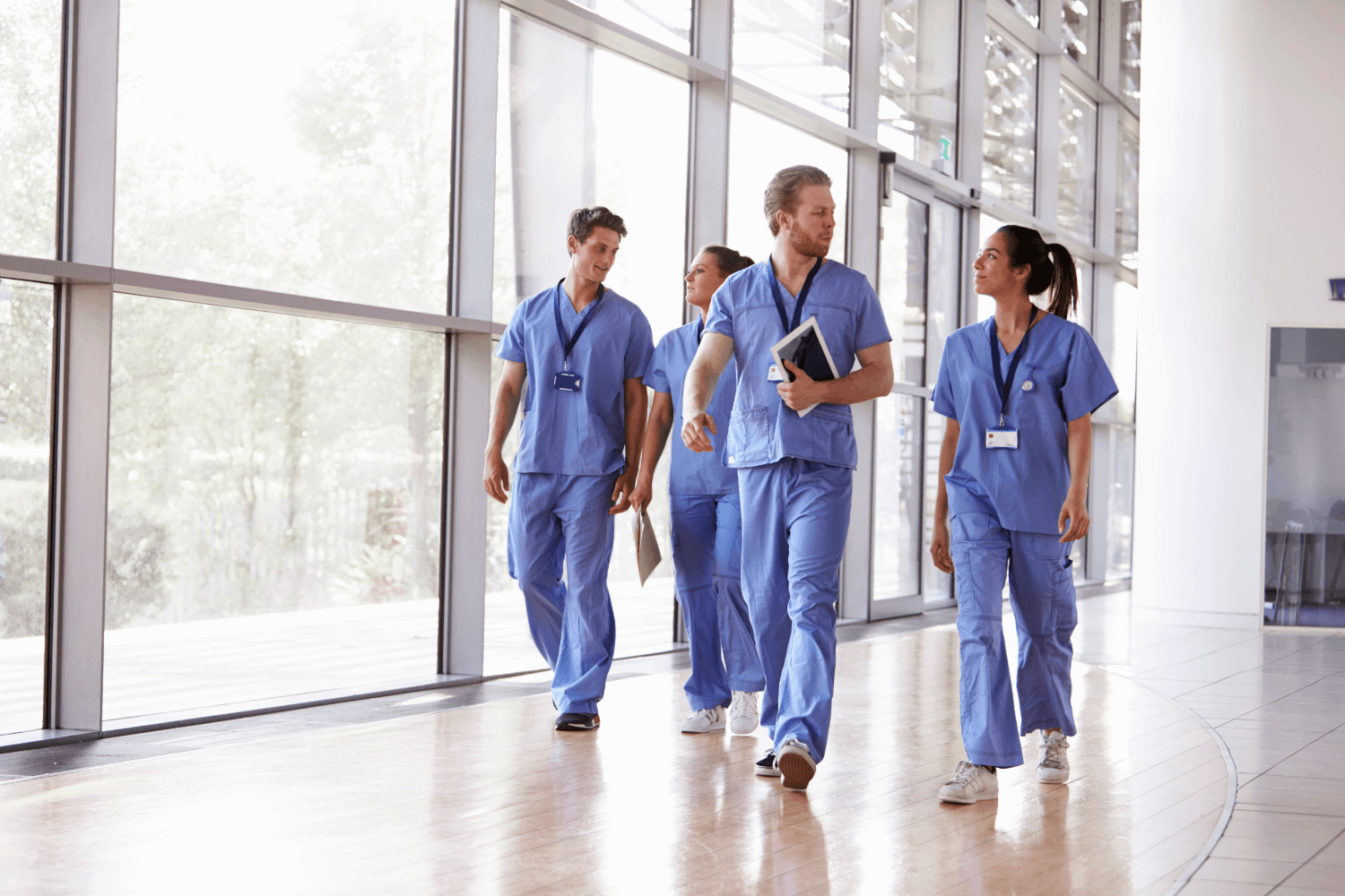 Group of people in scrubs walking