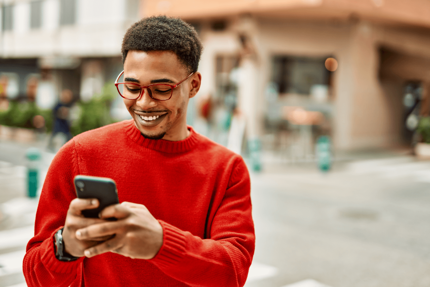 Smiling man using phone