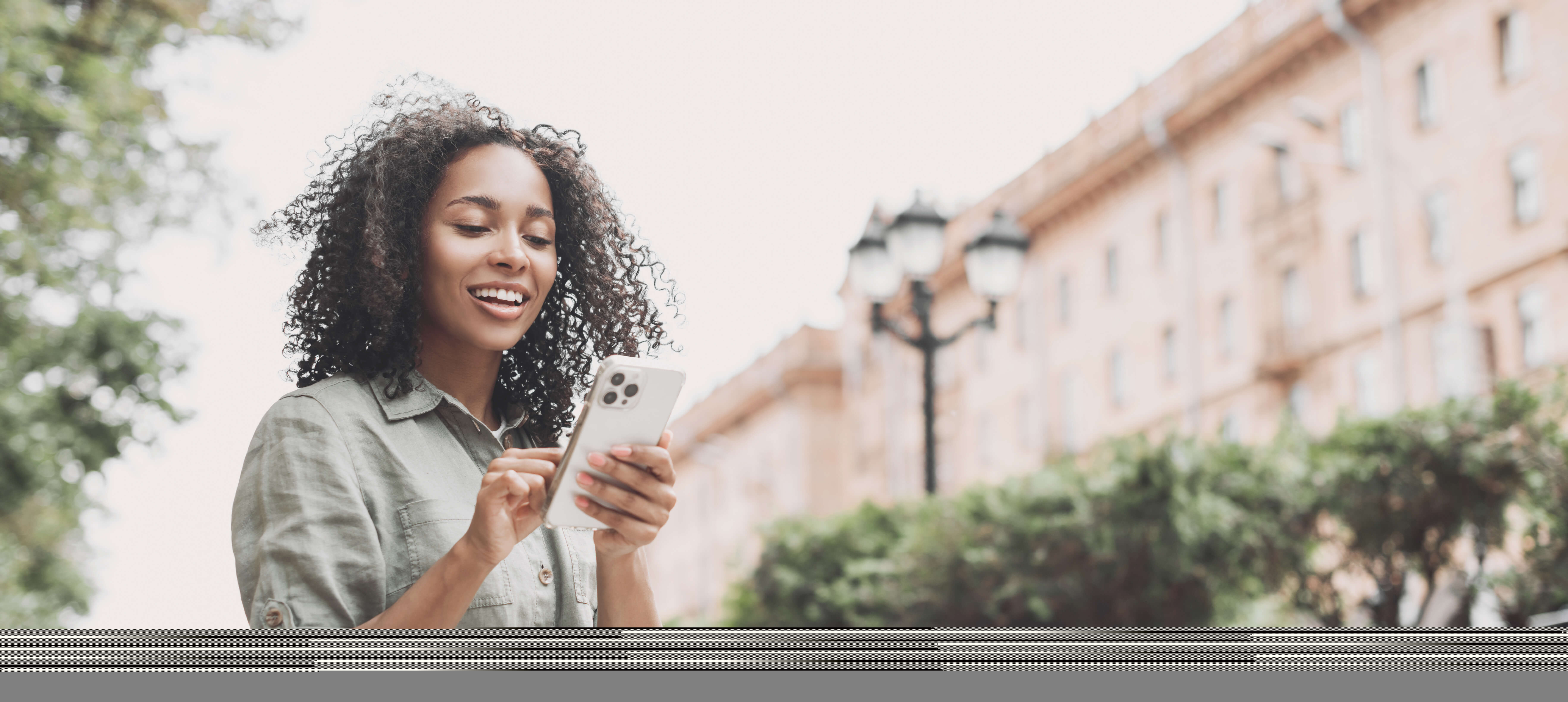 Smiling woman using phone